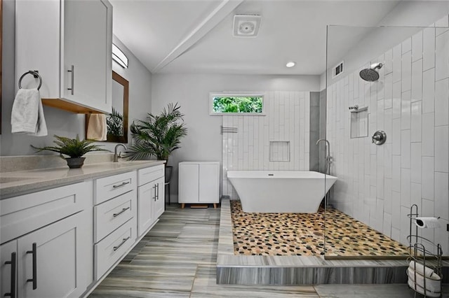 670 Parker Ave, Decatur, GA 30032 - full bathroom featuring double vanity, a freestanding tub, and a tile shower