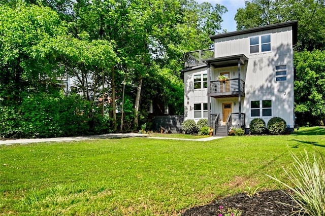 670 Parker Ave, Decatur, GA 30032 - view of front of house featuring a balcony, a front lawn, and board and batten siding