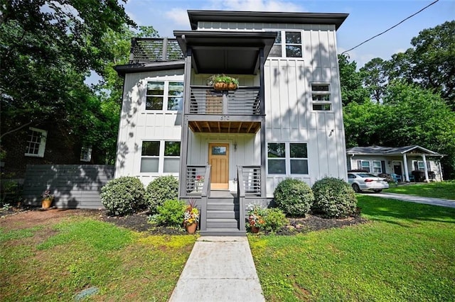 670 Parker Ave, Decatur, GA 30032 - view of front of property featuring a balcony, board and batten siding, and a front yard