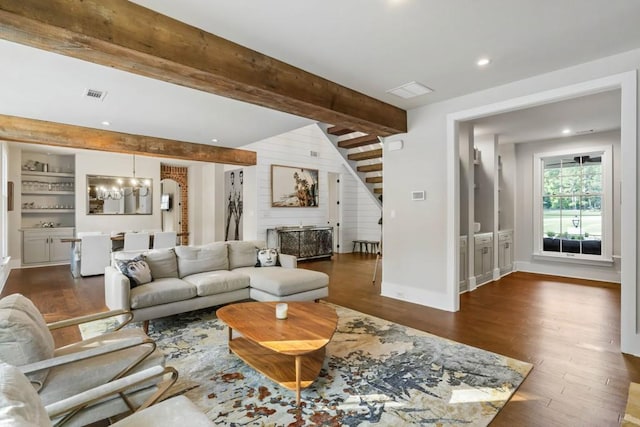 living room featuring stairs, a chandelier, beam ceiling, wood finished floors, and recessed lighting