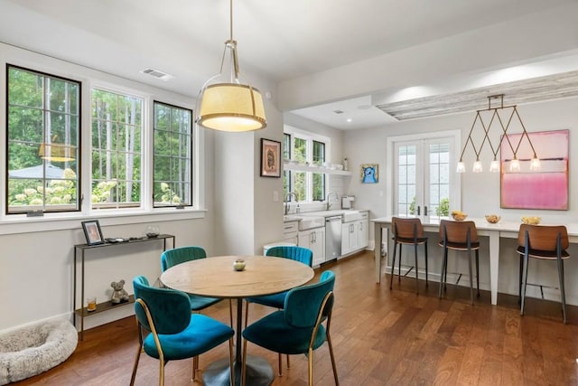 dining area featuring dark wood-style floors and baseboards