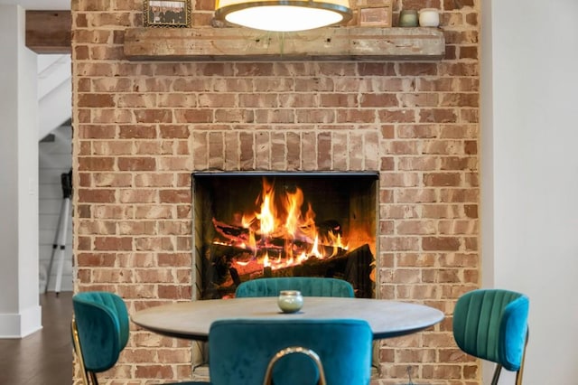 detailed view of a fireplace and wood finished floors