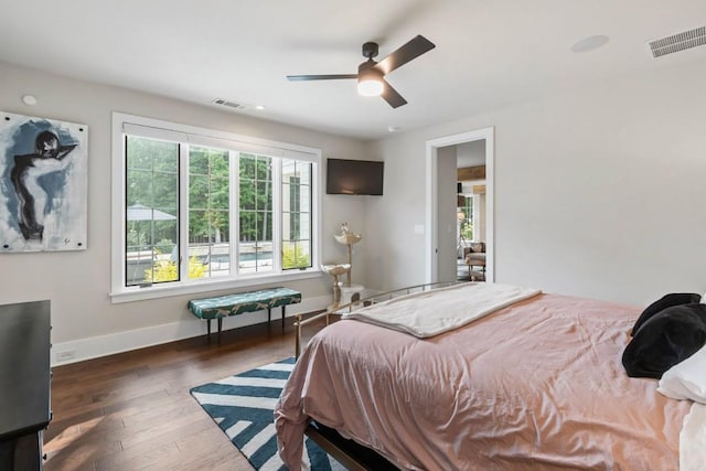 bedroom featuring baseboards, wood-type flooring, and ceiling fan