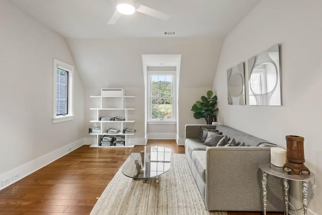 living room featuring a ceiling fan, lofted ceiling, wood finished floors, and baseboards