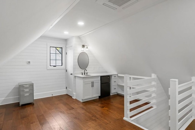 bathroom featuring lofted ceiling, hardwood / wood-style floors, baseboards, and vanity