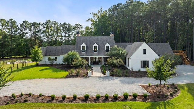 cape cod house with a chimney and gravel driveway