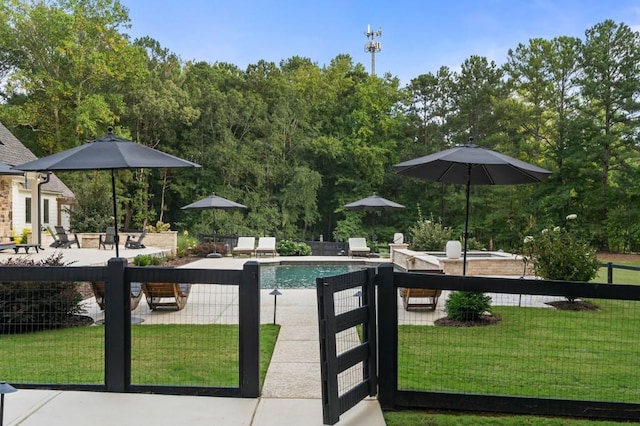 view of pool with a patio and a gate