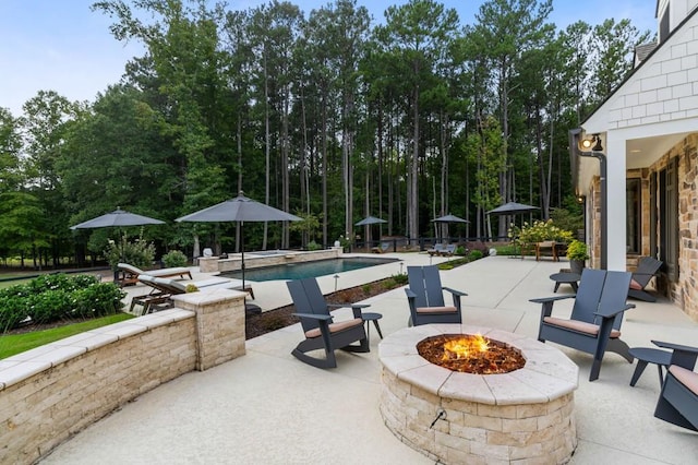 view of patio featuring an outdoor fire pit and an outdoor pool