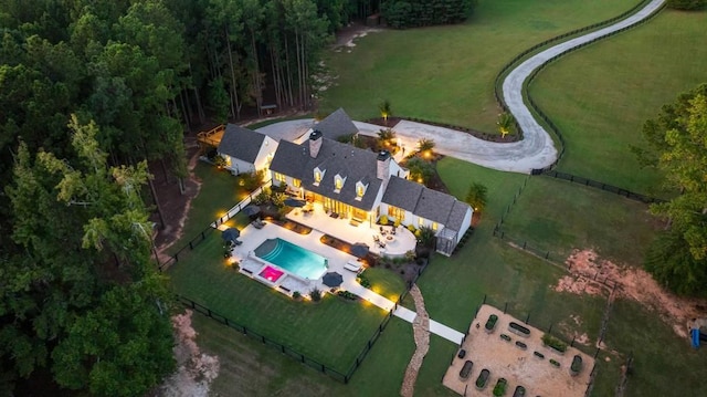 aerial view of property and surrounding area featuring a pool