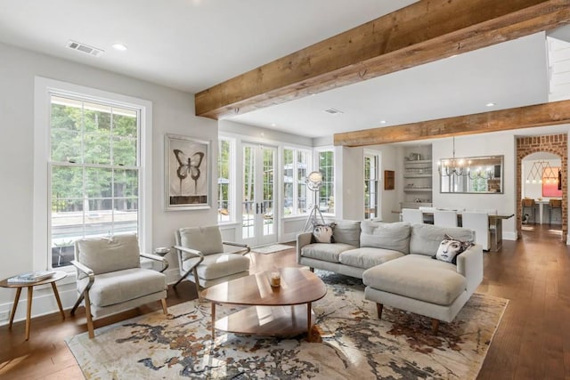 living area with beam ceiling, hardwood / wood-style flooring, recessed lighting, baseboards, and a chandelier