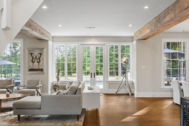 living room featuring wood finished floors, plenty of natural light, recessed lighting, baseboards, and french doors