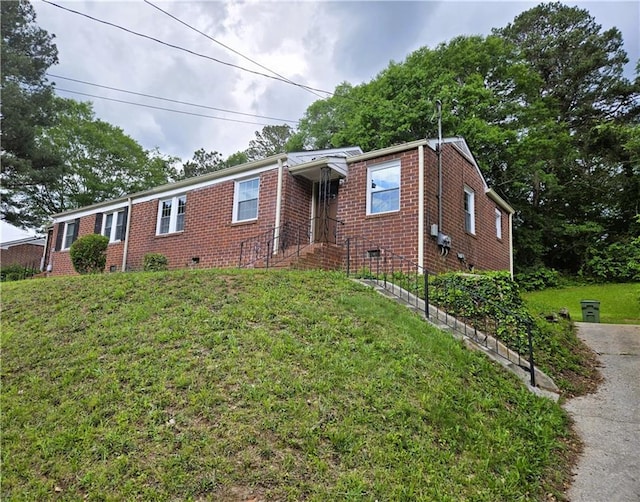 1753 Cahoon St SW, Atlanta, GA 30310 - view of front of house with a front yard, brick siding, and crawl space