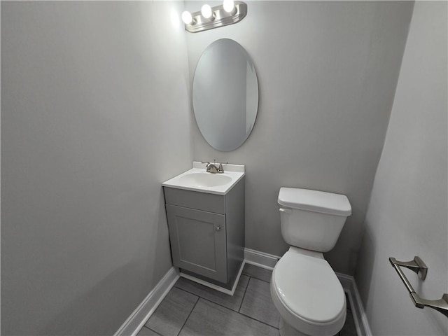 1753 Cahoon St SW, Atlanta, GA 30310 - half bathroom featuring toilet, vanity, tile patterned floors, and baseboards