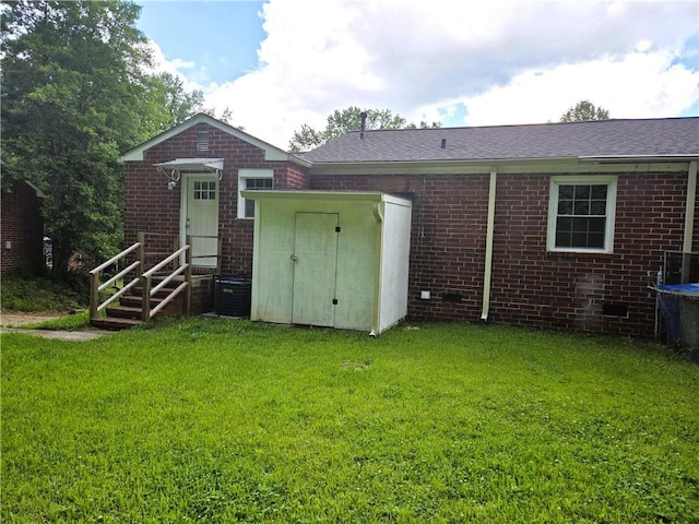 1753 Cahoon St SW, Atlanta, GA 30310 - rear view of property featuring brick siding, a lawn, cooling unit, and a shingled roof