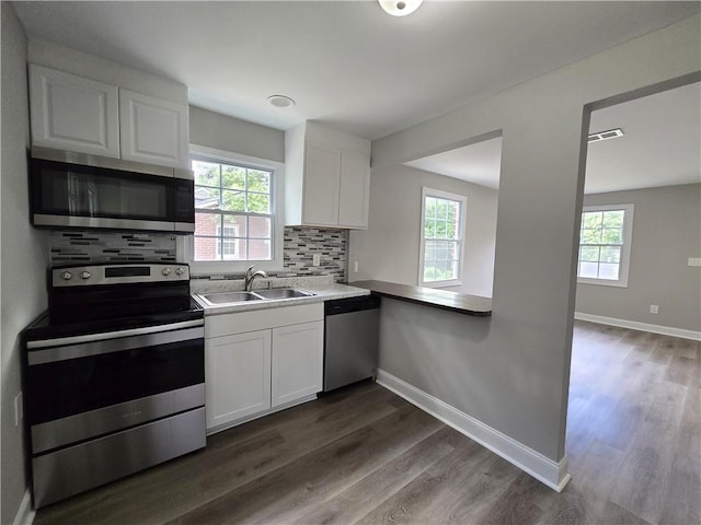 1753 Cahoon St SW, Atlanta, GA 30310 - kitchen featuring appliances with stainless steel finishes, a sink, healthy amount of natural light, and white cabinetry