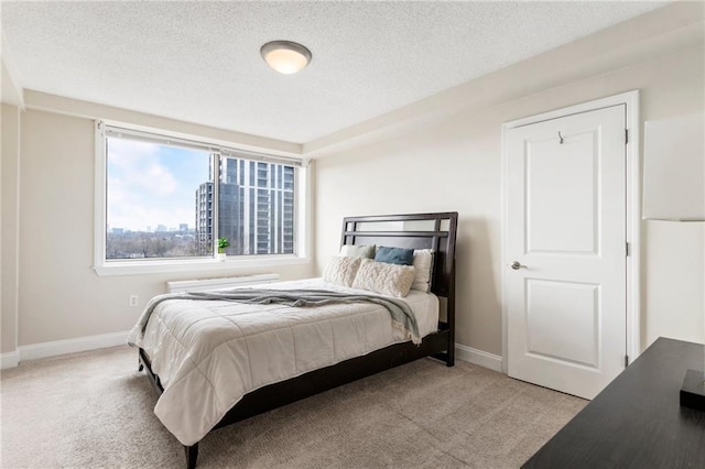 carpeted bedroom with a textured ceiling