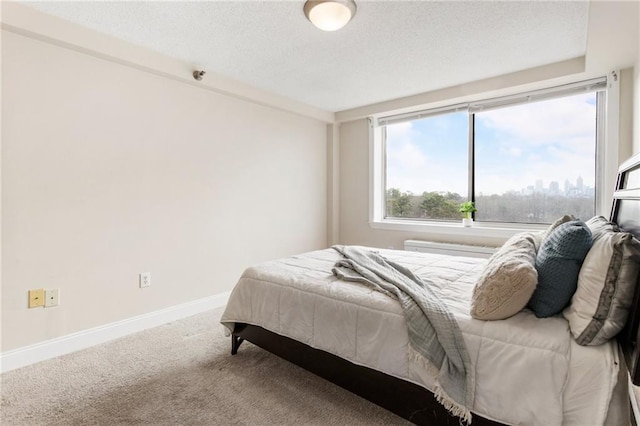 bedroom featuring a textured ceiling and carpet