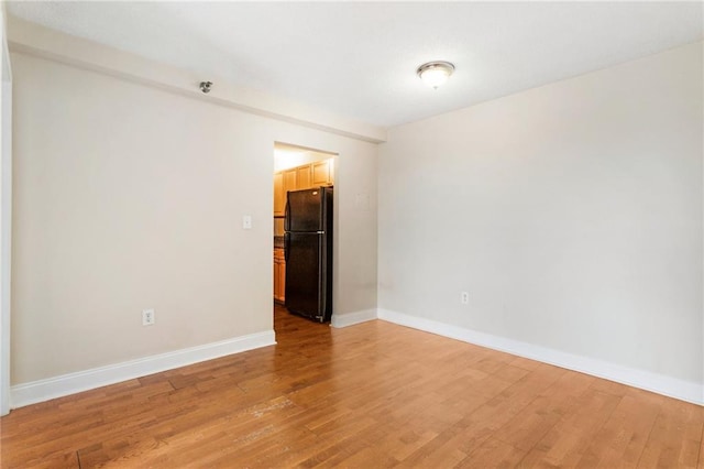 spare room featuring wood-type flooring