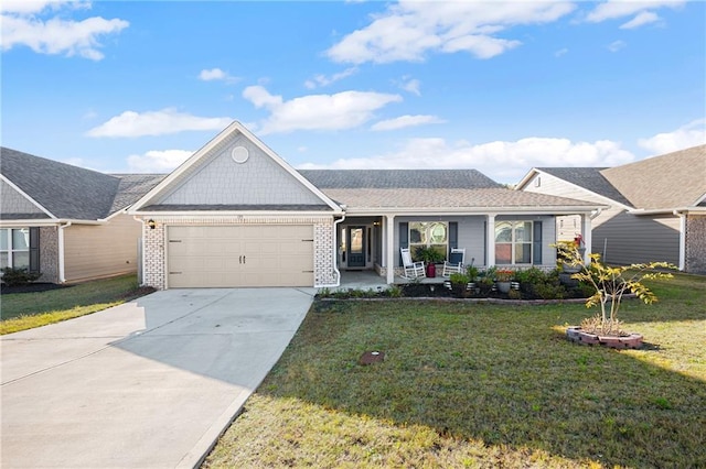 ranch-style home with covered porch, a front yard, and a garage