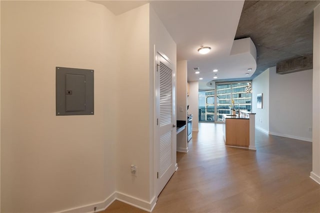 hallway with hardwood / wood-style flooring and electric panel