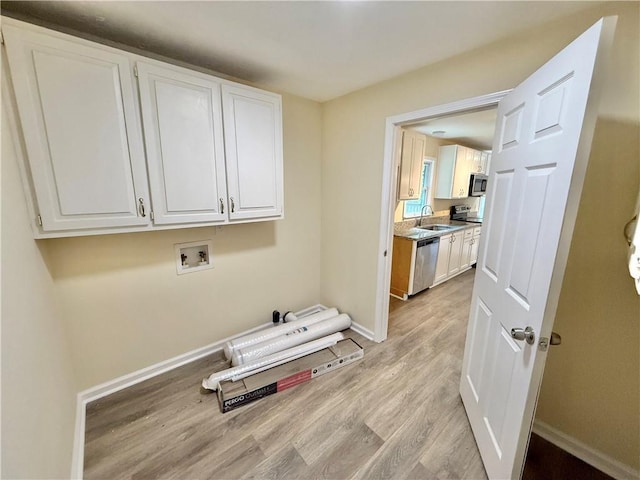 93 Mill Creek Rd, Hiram, GA 30141 - washroom with light wood-style flooring, a sink, cabinet space, washer hookup, and baseboards