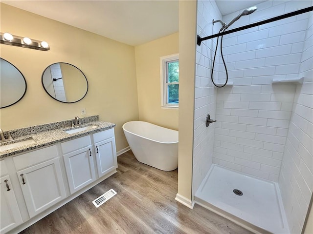 93 Mill Creek Rd, Hiram, GA 30141 - bathroom featuring double vanity, visible vents, wood finished floors, and a sink