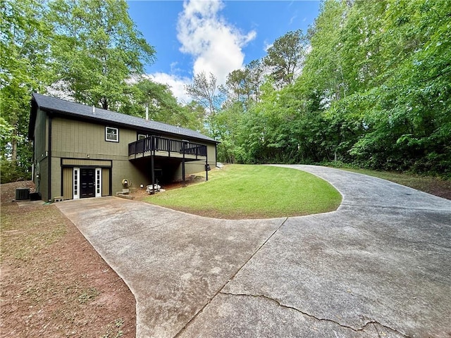 93 Mill Creek Rd, Hiram, GA 30141 - back of property with a deck, driveway, central AC, and a lawn
