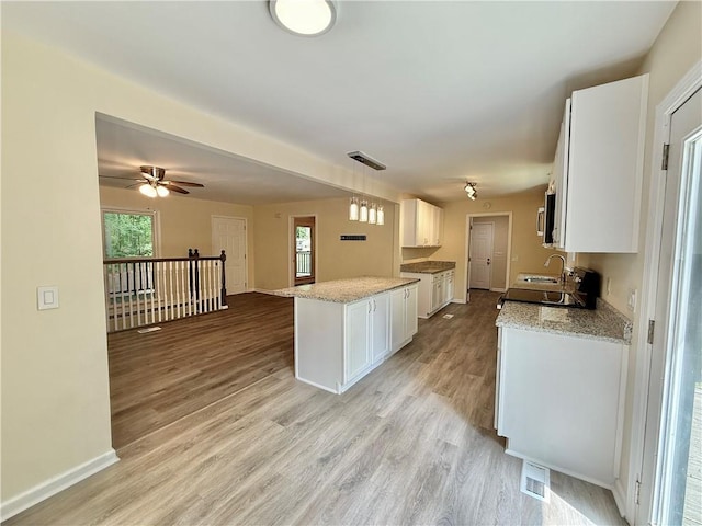 93 Mill Creek Rd, Hiram, GA 30141 - kitchen featuring ceiling fan, visible vents, a sink, white cabinetry, and light wood-style floors
