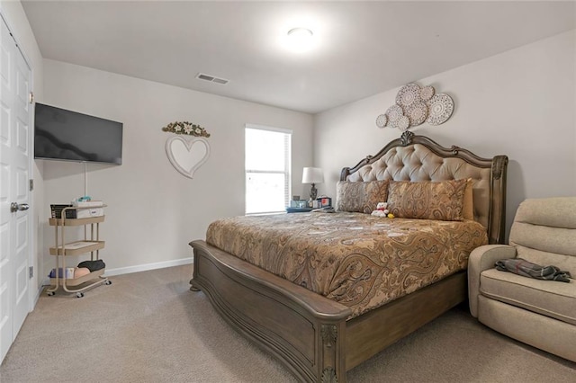 carpeted bedroom with visible vents and baseboards