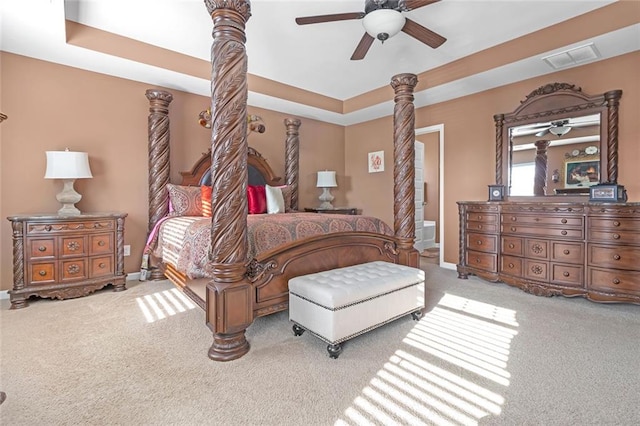 bedroom featuring carpet flooring, a ceiling fan, visible vents, baseboards, and a raised ceiling