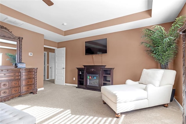 interior space featuring a raised ceiling, visible vents, and baseboards