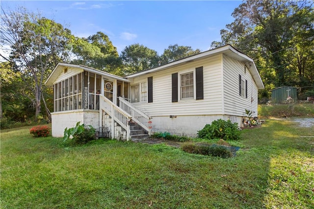 view of front of home with a front lawn and a sunroom