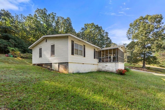 view of property exterior with a yard and a sunroom