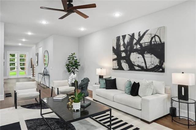 living room with hardwood / wood-style floors and ceiling fan