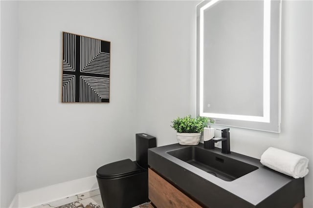 bathroom with tile patterned flooring, vanity, and toilet