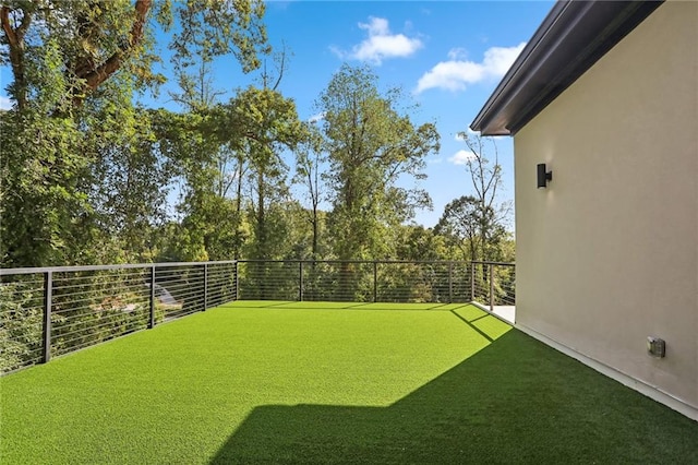 view of yard featuring a balcony