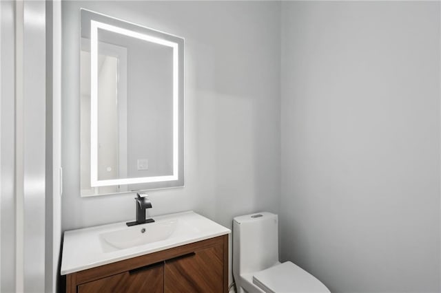 bathroom featuring vanity and toilet