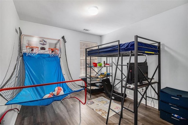 bedroom with hardwood / wood-style flooring