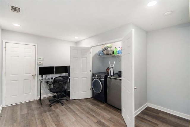 laundry area featuring wood-type flooring and separate washer and dryer