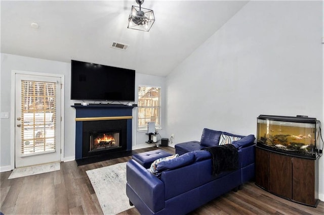 living room featuring lofted ceiling and dark hardwood / wood-style flooring