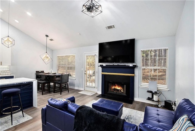 living room featuring lofted ceiling and hardwood / wood-style floors