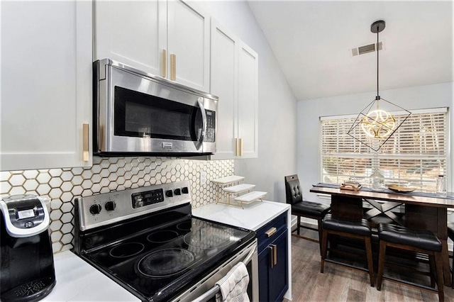 kitchen with white cabinetry, pendant lighting, and appliances with stainless steel finishes