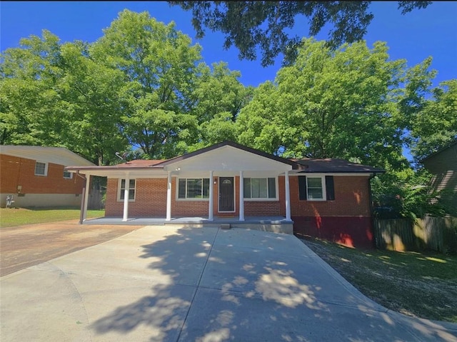 1150 Goldsmith Rd, Stone Mountain, GA 30083 - ranch-style home featuring driveway, covered porch, and brick siding