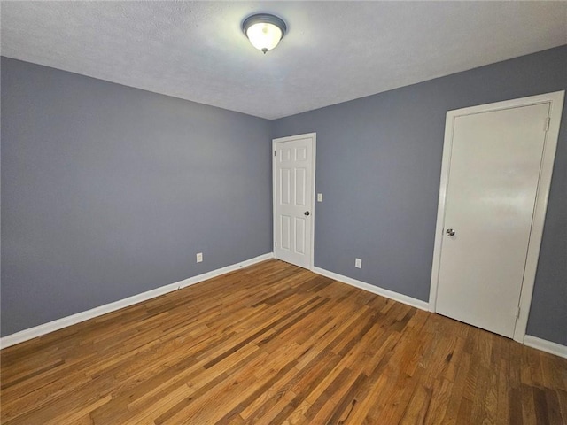1150 Goldsmith Rd, Stone Mountain, GA 30083 - unfurnished bedroom featuring wood finished floors and baseboards