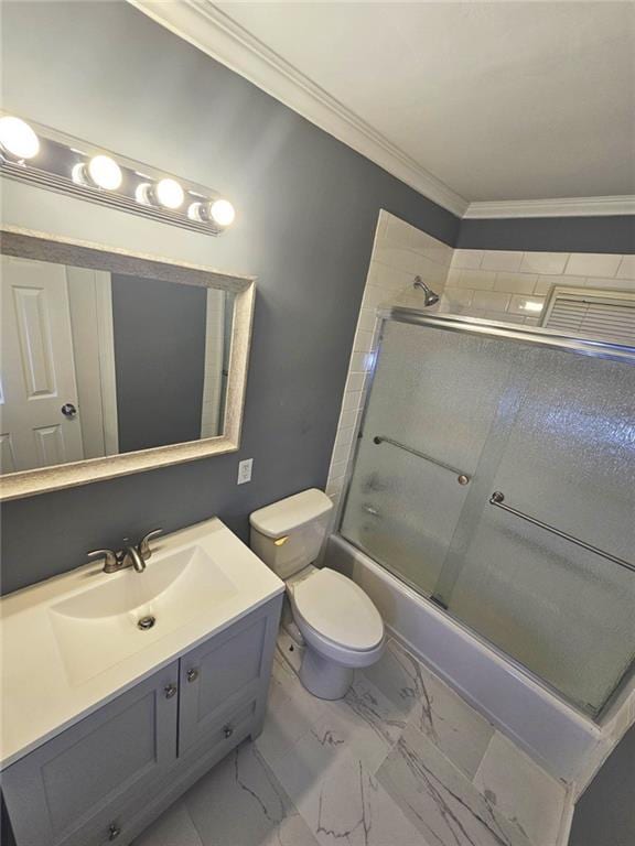 1150 Goldsmith Rd, Stone Mountain, GA 30083 - full bath featuring crown molding, bath / shower combo with glass door, vanity, toilet, and marble finish flooring