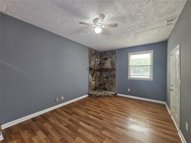 1150 Goldsmith Rd, Stone Mountain, GA 30083 - unfurnished bedroom featuring wood finished floors, a textured ceiling, baseboards, and a ceiling fan