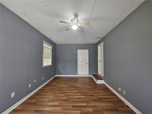 1150 Goldsmith Rd, Stone Mountain, GA 30083 - spare room featuring a ceiling fan, a textured ceiling, wood finished floors, and baseboards