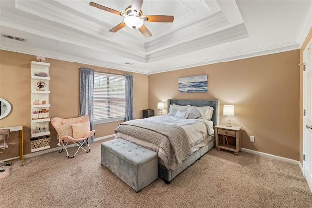 bedroom with light carpet, baseboards, a tray ceiling, and crown molding