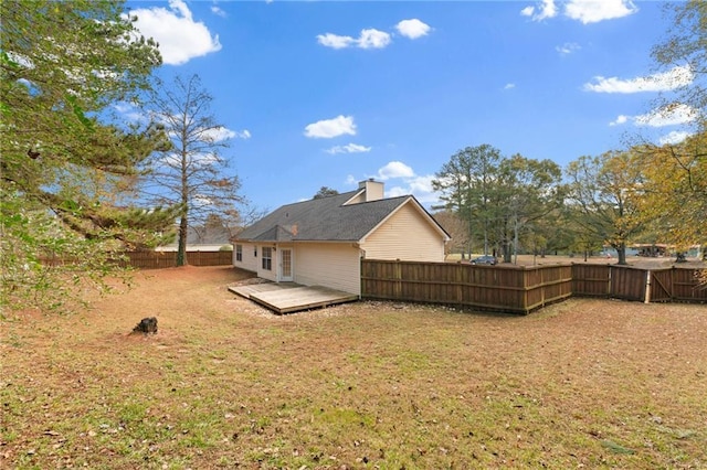 exterior space featuring a fenced backyard and a wooden deck