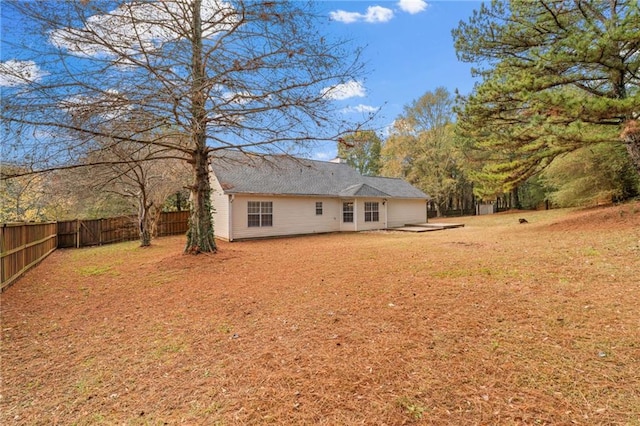 rear view of property featuring a patio area and fence